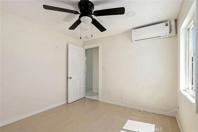 6681 Rostrata Ave, Buena Park, CA 90621 - empty room with a wall mounted air conditioner, light wood-style floors, and a ceiling fan