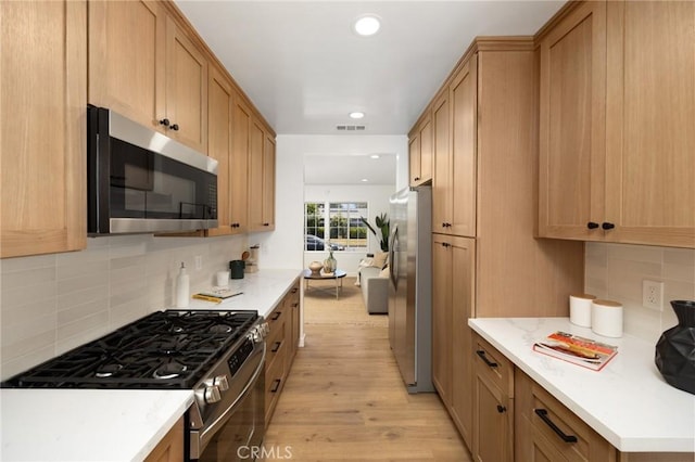 2231 Ocana Ave, Long Beach, CA 90815 - kitchen with stainless steel appliances, light wood-style floors, decorative backsplash, and recessed lighting