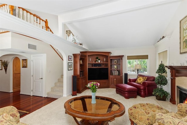 2531 Wildcat Ln, Riverside, CA 92503 - living room with arched walkways, stairway, high vaulted ceiling, a warm lit fireplace, and wood finished floors