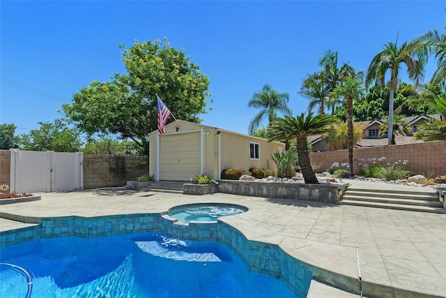 2531 Wildcat Ln, Riverside, CA 92503 - view of swimming pool with a pool with connected hot tub, a fenced backyard, a patio area, and an outbuilding