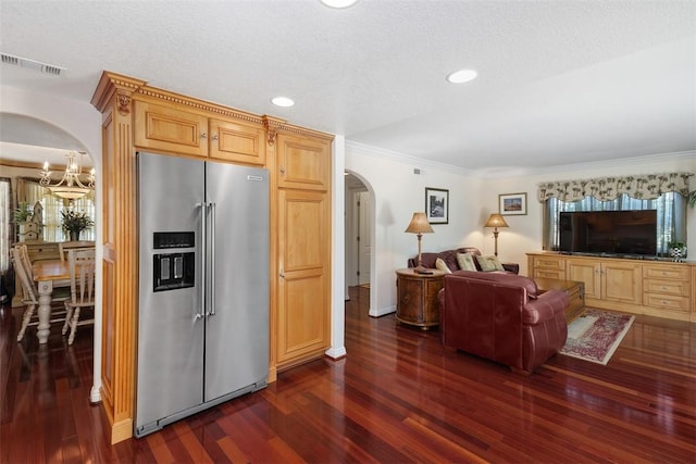 2531 Wildcat Ln, Riverside, CA 92503 - living room featuring arched walkways, dark wood-style flooring, ornamental molding, recessed lighting, and a chandelier