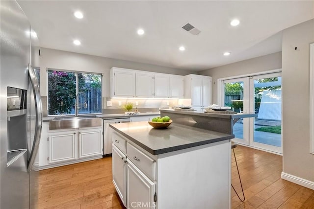 591 Shadow Tree Dr, Oceanside, CA 92058 - kitchen featuring appliances with stainless steel finishes, light wood finished floors, white cabinets, and recessed lighting