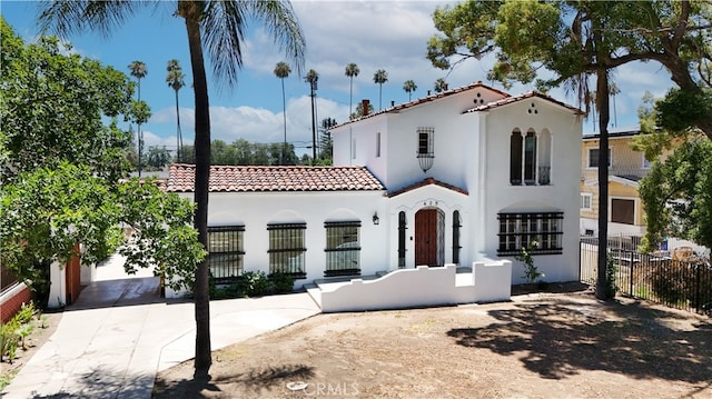 425 W 17th St, San Bernardino, CA 92405 - mediterranean / spanish-style house featuring a tile roof, stucco siding, and driveway