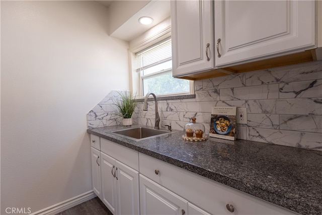 425 W 17th St, San Bernardino, CA 92405 - kitchen featuring white cabinets, tasteful backsplash, dark stone counters, and dark wood finished floors