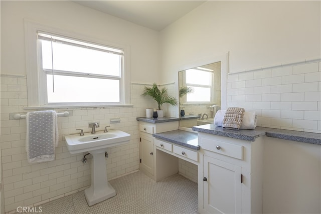 425 W 17th St, San Bernardino, CA 92405 - bathroom featuring tile walls, tile patterned floors, a wainscoted wall, and tasteful backsplash