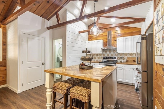 35853 Sierra Linda Dr, Wishon, CA 93669 - kitchen with butcher block counters, wall chimney exhaust hood, appliances with stainless steel finishes, wood walls, and white cabinetry
