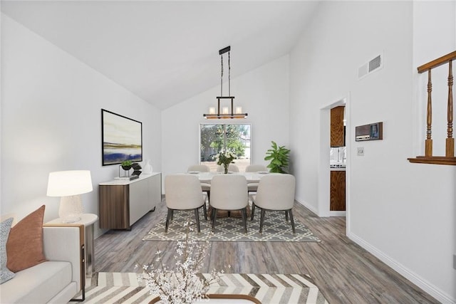 601 Las Arenas Ct, Bakersfield, CA 93314 - dining area with a chandelier, wood finished floors, and high vaulted ceiling