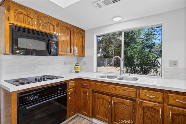 601 Las Arenas Ct, Bakersfield, CA 93314 - kitchen featuring black appliances, decorative backsplash, light countertops, and brown cabinets