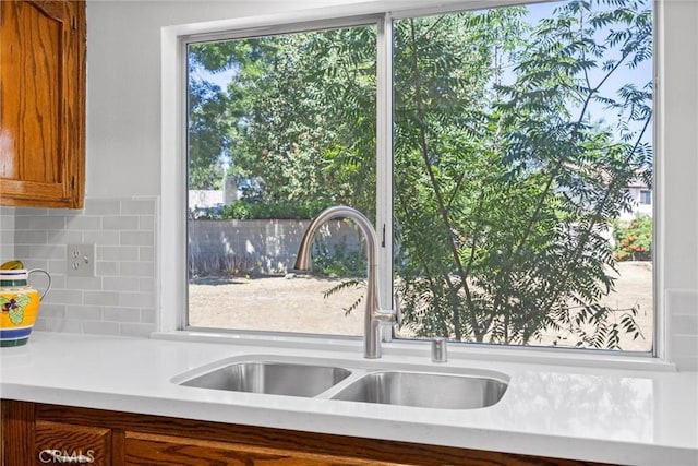 601 Las Arenas Ct, Bakersfield, CA 93314 - kitchen featuring light countertops, decorative backsplash, and brown cabinets