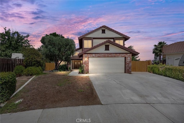 601 Las Arenas Ct, Bakersfield, CA 93314 - traditional-style house featuring driveway, brick siding, an attached garage, and a tiled roof