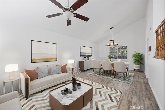 601 Las Arenas Ct, Bakersfield, CA 93314 - living room with wood finished floors, high vaulted ceiling, a ceiling fan, and a chandelier
