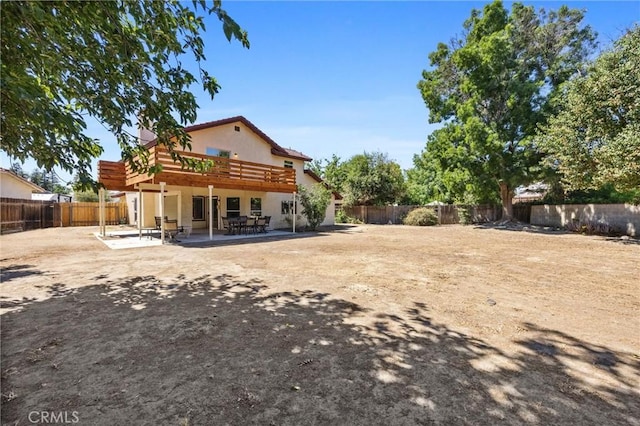601 Las Arenas Ct, Bakersfield, CA 93314 - rear view of property with a fenced backyard, a patio, a wooden deck, and stucco siding