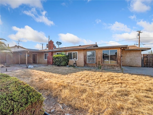 17911 Juniper St, Hesperia, CA 92345 - back of property featuring a chimney, a patio, and stucco siding