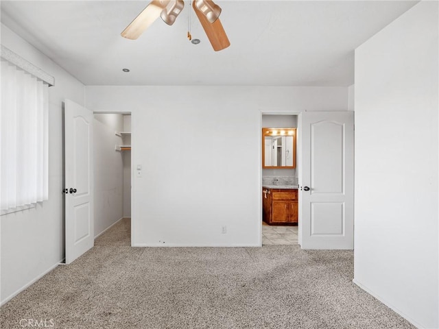 17911 Juniper St, Hesperia, CA 92345 - unfurnished bedroom featuring light colored carpet, a spacious closet, a ceiling fan, and ensuite bathroom