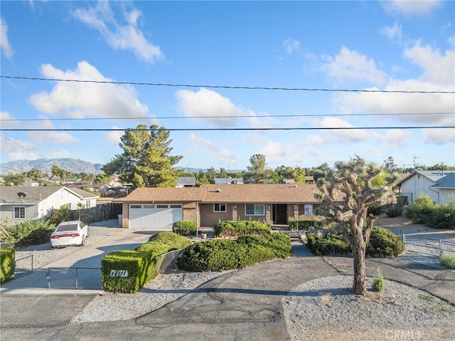 17911 Juniper St, Hesperia, CA 92345 - ranch-style home featuring concrete driveway, a garage, a mountain view, and a residential view