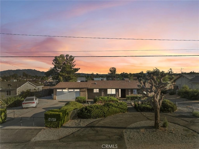 17911 Juniper St, Hesperia, CA 92345 - ranch-style house featuring a garage, concrete driveway, and a residential view