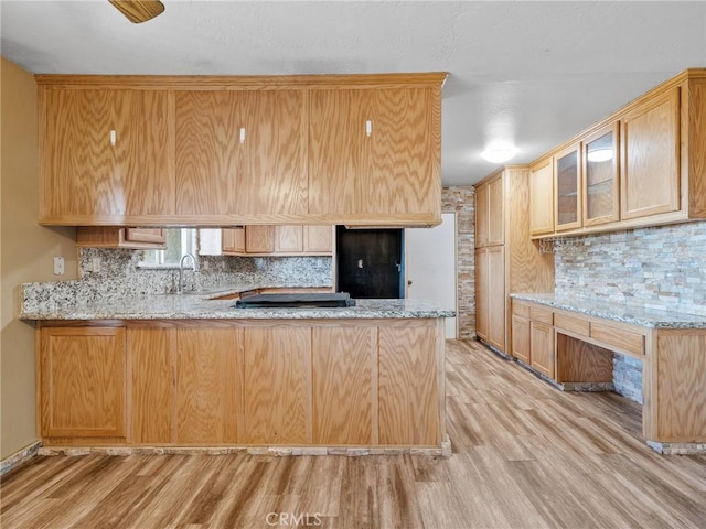 17911 Juniper St, Hesperia, CA 92345 - kitchen with a peninsula, light wood-type flooring, decorative backsplash, light stone counters, and glass insert cabinets