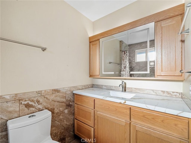 17911 Juniper St, Hesperia, CA 92345 - full bathroom featuring vanity, tile walls, and a wainscoted wall