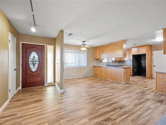17911 Juniper St, Hesperia, CA 92345 - kitchen featuring a peninsula, plenty of natural light, and light wood finished floors