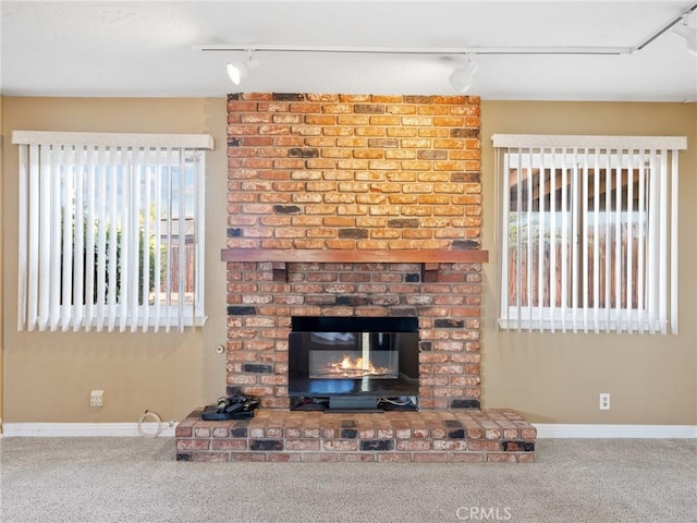 17911 Juniper St, Hesperia, CA 92345 - unfurnished living room with track lighting, carpet flooring, and plenty of natural light