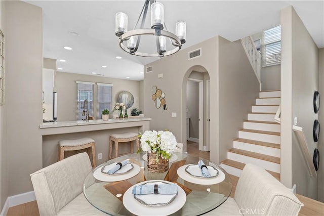 14 Tall Oak, Irvine, CA 92603 - dining room featuring arched walkways, a chandelier, stairs, wood finished floors, and recessed lighting