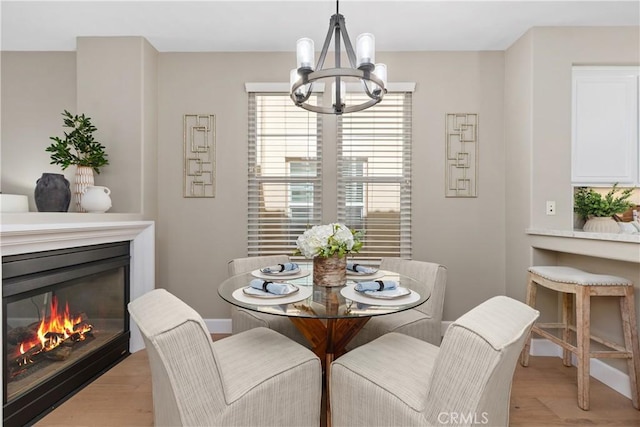 14 Tall Oak, Irvine, CA 92603 - dining area featuring a chandelier, a glass covered fireplace, and light wood finished floors