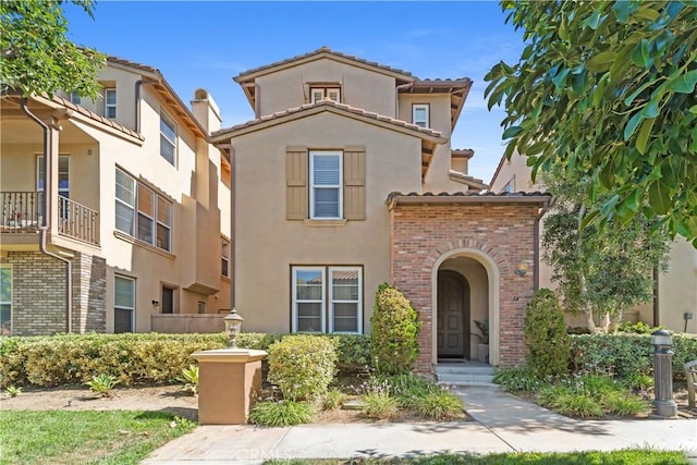 14 Tall Oak, Irvine, CA 92603 - mediterranean / spanish-style house with stucco siding, a tile roof, and brick siding