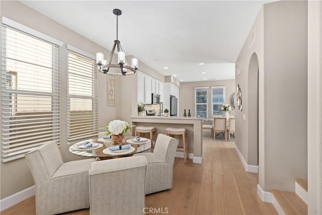 14 Tall Oak, Irvine, CA 92603 - dining room featuring a chandelier, light wood-type flooring, recessed lighting, and arched walkways