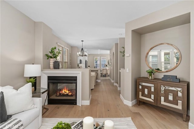 14 Tall Oak, Irvine, CA 92603 - living area featuring light wood-style flooring, a chandelier, and a multi sided fireplace