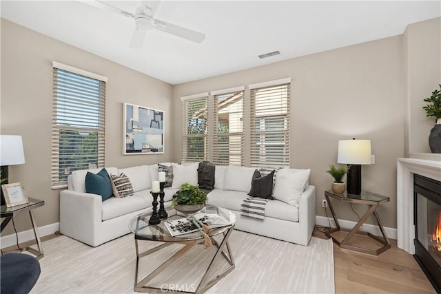 14 Tall Oak, Irvine, CA 92603 - living room with light wood-style floors, a ceiling fan, and a glass covered fireplace