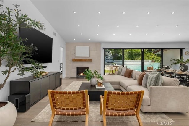 4764 Browndeer Ln, Rancho Palos Verdes, CA 90275 - living room featuring light wood-style flooring, a warm lit fireplace, and recessed lighting