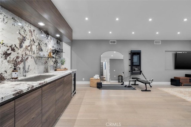 4764 Browndeer Ln, Rancho Palos Verdes, CA 90275 - indoor wet bar featuring arched walkways, recessed lighting, light wood-style floors, and beverage cooler