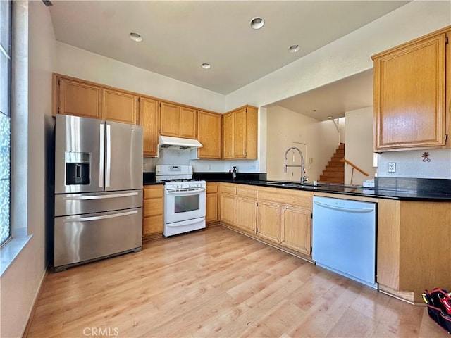 2244 Posada Ct, Corona, CA 92879 - kitchen featuring white appliances, dark countertops, under cabinet range hood, light wood-style flooring, and recessed lighting
