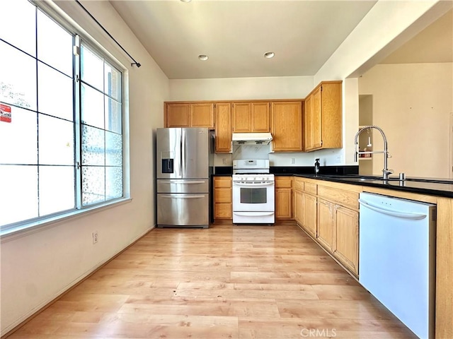 2244 Posada Ct, Corona, CA 92879 - kitchen featuring white appliances, under cabinet range hood, plenty of natural light, dark countertops, and recessed lighting