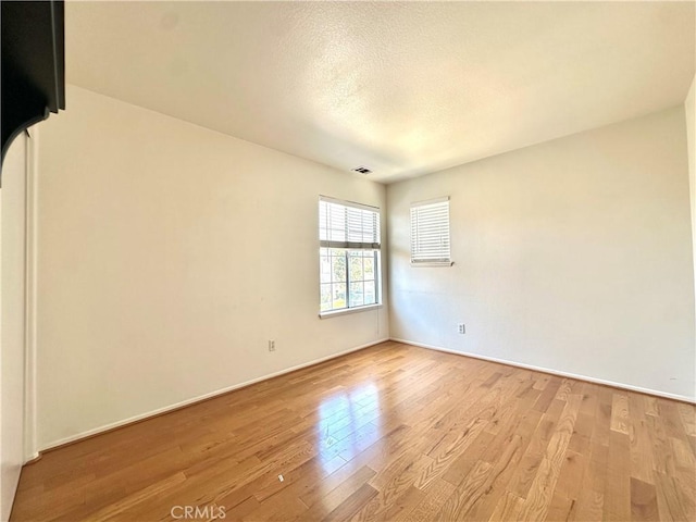 2244 Posada Ct, Corona, CA 92879 - unfurnished room with light wood-type flooring and a textured ceiling