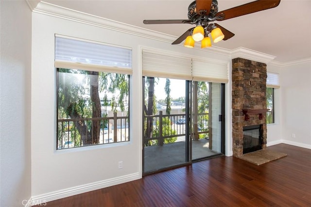 2567 Plaza Del Amo Unit 205, Torrance, CA 90503 - doorway with ornamental molding, a ceiling fan, wood finished floors, and a stone fireplace