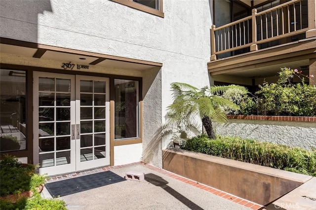 2567 Plaza Del Amo Unit 205, Torrance, CA 90503 - doorway to property featuring french doors, stucco siding, and a balcony