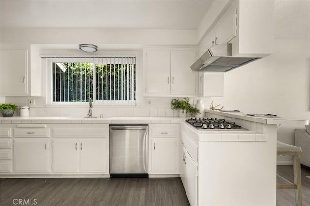 557 S Gardner Dr, Orange, CA 92866 - kitchen with stainless steel appliances, exhaust hood, white cabinets, tile countertops, and a breakfast bar