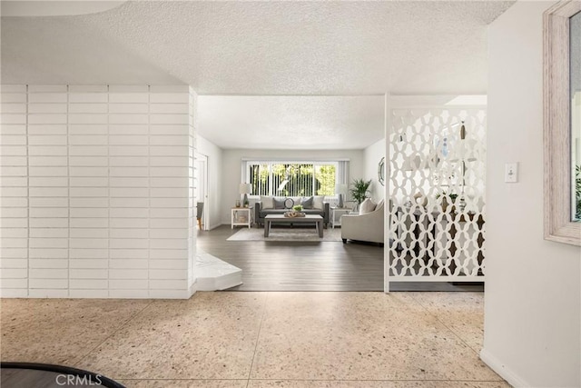 557 S Gardner Dr, Orange, CA 92866 - living room featuring a textured ceiling and baseboards