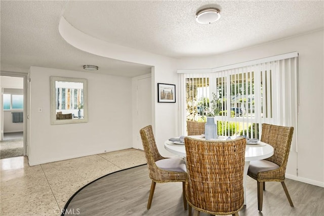 557 S Gardner Dr, Orange, CA 92866 - dining space featuring a textured ceiling and plenty of natural light
