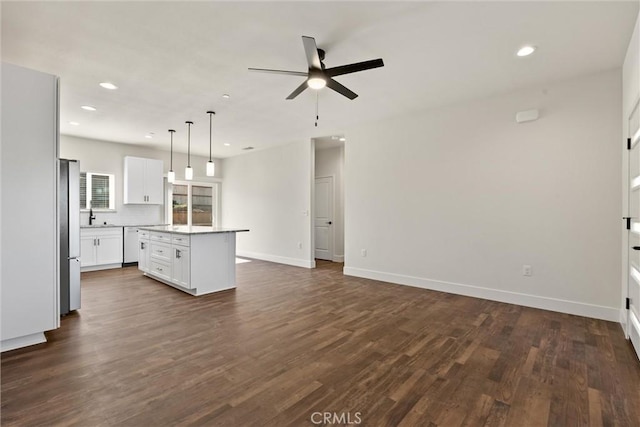 5616 Glen Way, Paradise, CA 95969 - kitchen with freestanding refrigerator, a ceiling fan, open floor plan, a kitchen island, and dark wood-style floors