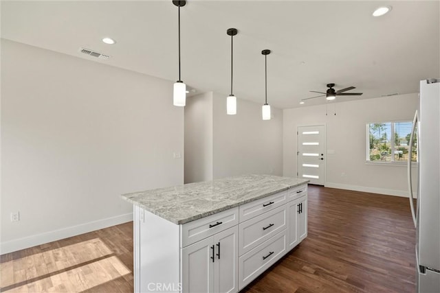 5616 Glen Way, Paradise, CA 95969 - kitchen featuring freestanding refrigerator, ceiling fan, a kitchen island, white cabinetry, and dark wood-style floors