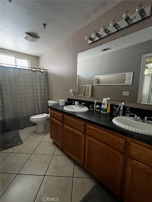 2932 Prospect Ave, Riverside, CA 92507 - full bath with double vanity, tile patterned floors, a shower with shower curtain, and a textured ceiling
