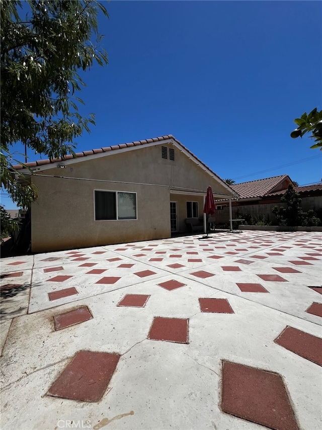 2932 Prospect Ave, Riverside, CA 92507 - rear view of property with stucco siding, a patio, and a tile roof