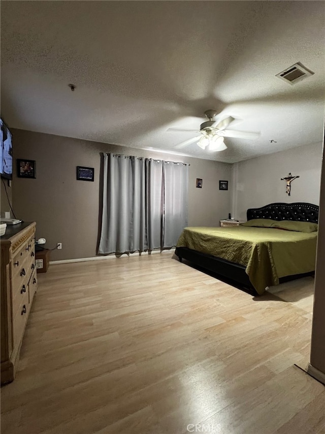 2932 Prospect Ave, Riverside, CA 92507 - bedroom with a textured ceiling, light wood-type flooring, and ceiling fan