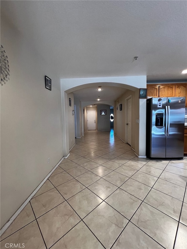 2932 Prospect Ave, Riverside, CA 92507 - hall with arched walkways and light tile patterned floors