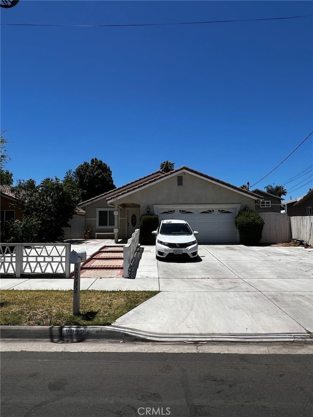 2932 Prospect Ave, Riverside, CA 92507 - ranch-style home featuring driveway, an attached garage, and stucco siding