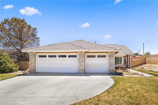 3310 Purple Sage Ln, Palmdale, CA 93550 - view of front of house featuring a garage, driveway, stone siding, and a tiled roof