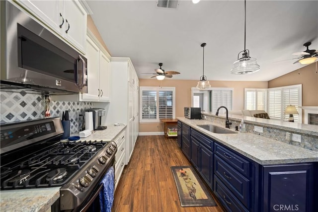 3310 Purple Sage Ln, Palmdale, CA 93550 - kitchen featuring stainless steel appliances, ceiling fan, blue cabinets, white cabinets, and lofted ceiling