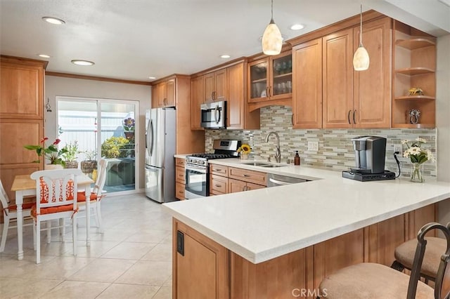18912 Circle Of The Oaks, Newhall, CA 91321 - kitchen featuring appliances with stainless steel finishes, brown cabinetry, a peninsula, light countertops, and backsplash